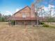 Two-story house with brown siding, large yard, and covered porch at 17952 Lookout Hill Rd, Winter Garden, FL 34787