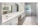 Bathroom with double vanity, a large mirror, and a soaking tub at 1878 Algonquin Ave, Deltona, FL 32725