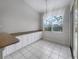 Eat-in kitchen with granite countertops and white cabinets at 1878 Algonquin Ave, Deltona, FL 32725