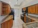 Kitchen with wood cabinets, granite counters, and stainless steel appliances at 1878 Algonquin Ave, Deltona, FL 32725