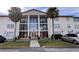 Condo building exterior with palm trees and ample parking at 1902 Honour Rd # 9, Orlando, FL 32839