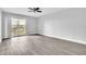 Bright, airy bedroom with vinyl flooring, ceiling fan, neutral walls, and balcony access at 1932 Lake Atriums Cir # 69, Orlando, FL 32839