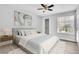 This bedroom features wood-look flooring, a ceiling fan, a walk-in closet, and a bright window at 1932 Lake Atriums Cir # 69, Orlando, FL 32839