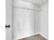 Walk-in closet with painted white walls, white shelving, and wood look flooring at 1932 Lake Atriums Cir # 69, Orlando, FL 32839