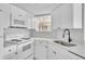 Bright kitchen with white cabinets, modern appliances, and updated countertops at 1932 Lake Atriums Cir # 69, Orlando, FL 32839