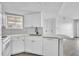 Bright kitchen with white cabinets, modern appliances, updated countertops, and stainless steel sink at 1932 Lake Atriums Cir # 69, Orlando, FL 32839
