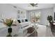 Living room featuring modern decor, ceiling fan, outdoor access, stylish furniture, and neutral color palette at 1932 Lake Atriums Cir # 69, Orlando, FL 32839
