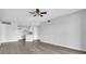 Open-concept living area with vinyl floors, neutral walls, ceiling fan, and access to the kitchen at 1932 Lake Atriums Cir # 69, Orlando, FL 32839