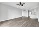 Open-concept living area with vinyl floors, neutral walls, ceiling fan, and access to the kitchen at 1932 Lake Atriums Cir # 69, Orlando, FL 32839
