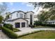 Modern home exterior with a two-car garage and landscaped yard at 210 E Lake Sue Ave, Winter Park, FL 32789