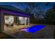 Night view of a luxurious pool and patio area with modern furniture and lighting at 210 E Lake Sue Ave, Winter Park, FL 32789