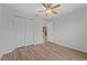 Bedroom with wood-look floors, ceiling fan and double closet at 3362 Robert Trent Jones Dr # 30307, Orlando, FL 32835