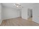 Bright bedroom with wood-look floors and ceiling fan at 3362 Robert Trent Jones Dr # 30307, Orlando, FL 32835
