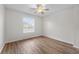 Well-lit bedroom featuring wood-look floors and large window at 3362 Robert Trent Jones Dr # 30307, Orlando, FL 32835