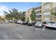 Condo building with parking lot and surrounding trees at 3362 Robert Trent Jones Dr # 30307, Orlando, FL 32835