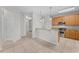 Kitchen with island, granite countertops, and wood cabinets at 3362 Robert Trent Jones Dr # 30307, Orlando, FL 32835