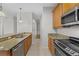 Kitchen with stainless steel appliances and wood cabinets at 3362 Robert Trent Jones Dr # 30307, Orlando, FL 32835
