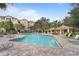 Community pool with lounge chairs and covered patio at 3362 Robert Trent Jones Dr # 30307, Orlando, FL 32835