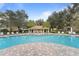 Community pool with lounge chairs and patio area at 3362 Robert Trent Jones Dr # 30307, Orlando, FL 32835