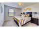 Bedroom with yellow and grey striped bedding at 3814 Royal Azalea Way, Sanford, FL 32773