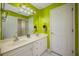 Bathroom with double vanity and lime green walls at 412 Vista Dr, Davenport, FL 33897