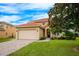 Two story house with attached garage and manicured lawn at 412 Vista Dr, Davenport, FL 33897
