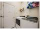 Laundry room with washer, dryer, and shelving at 412 Vista Dr, Davenport, FL 33897