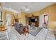 Spacious living room with tile floors, comfortable seating, and a large TV at 412 Vista Dr, Davenport, FL 33897
