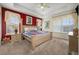 Spacious main bedroom with a king-size bed and rich red accent wall at 412 Vista Dr, Davenport, FL 33897