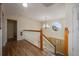 Upstairs hallway with wood floors and oak railing at 412 Vista Dr, Davenport, FL 33897
