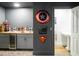 Basement bar with wet bar, mini-fridge, and adjacent bathroom at 4510 Packard S Ave, St Cloud, FL 34772