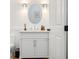 Elegant powder room with white vanity and a round mirror at 4510 Packard S Ave, St Cloud, FL 34772