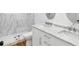 Modern bathroom with double vanity, marble tile, and walk-in shower at 4510 Packard S Ave, St Cloud, FL 34772