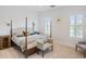 Spacious bedroom with a comfortable bed, sitting area, and ample natural light at 4510 Packard S Ave, St Cloud, FL 34772