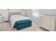 Cozy bedroom with beige headboard, teal bench, and white dresser at 4510 Packard S Ave, St Cloud, FL 34772