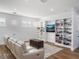 Spacious game room featuring built-in shelving, comfortable seating, and a large TV at 4510 Packard S Ave, St Cloud, FL 34772