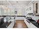 Bright kitchen with a large island, white cabinets, and black countertops at 4510 Packard S Ave, St Cloud, FL 34772