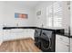 Bright laundry room with white cabinets and high-end appliances at 4510 Packard S Ave, St Cloud, FL 34772