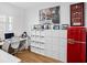 Home office with built-in shelving and a retro red refrigerator at 4510 Packard S Ave, St Cloud, FL 34772