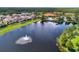 Aerial view of community with lake and homes at 4732 Vero Beach Pl, Kissimmee, FL 34746