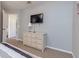 Bedroom with dresser, TV, and access to hallway at 4732 Vero Beach Pl, Kissimmee, FL 34746
