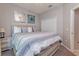 King-size bed with striped bedding and nightstand at 4732 Vero Beach Pl, Kissimmee, FL 34746