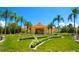 Community clubhouse with landscaping and palm trees at 4732 Vero Beach Pl, Kissimmee, FL 34746