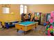 Community game room with arcade games and pool table at 4732 Vero Beach Pl, Kissimmee, FL 34746