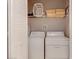 Stackable washer and dryer in a well-lit laundry closet at 4732 Vero Beach Pl, Kissimmee, FL 34746