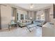 Spacious living room with light gray sofas and a glass coffee table at 4732 Vero Beach Pl, Kissimmee, FL 34746