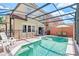 Screened-in pool with patio furniture and safety fence at 4732 Vero Beach Pl, Kissimmee, FL 34746