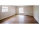 Bedroom with wood floors and two windows, offers plenty of natural light at 585 Gasline Rd, Deland, FL 32724