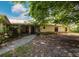 A single-story home featuring a front yard, walkway and trees, offers curb appeal and a welcoming entrance at 585 Gasline Rd, Deland, FL 32724