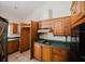 Traditional kitchen with wooden cabinets and dated appliances at 585 Gasline Rd, Deland, FL 32724